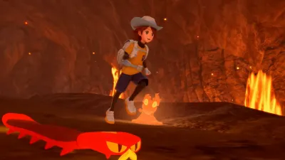 The protagonist running past lava plumes inside a volcanic cave